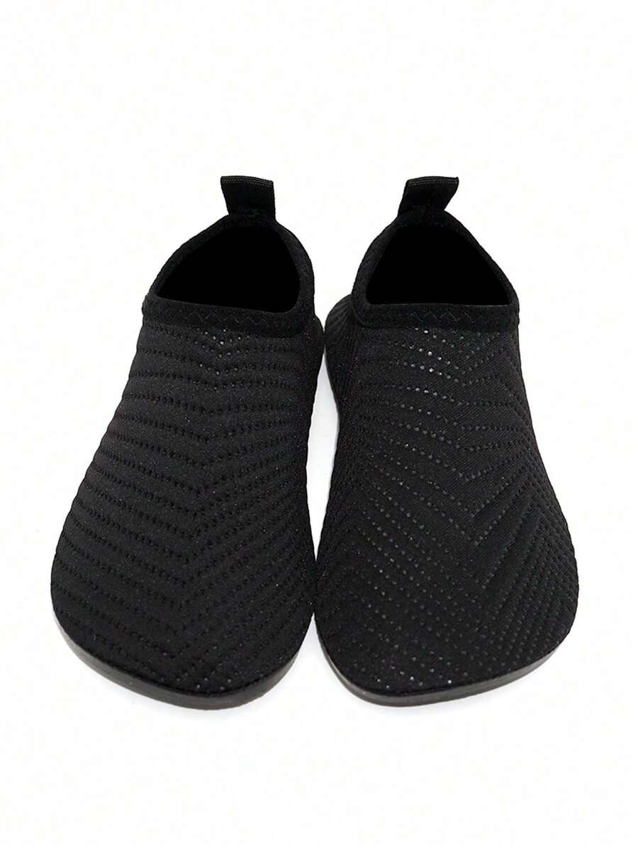 Black breathable slip-on aqua socks for boys featuring polyester material and TPR outsole.