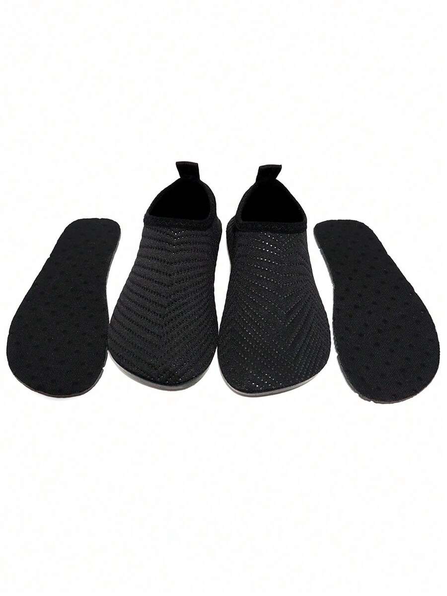 Black breathable slip-on aqua socks for boys featuring polyester material and TPR outsole.