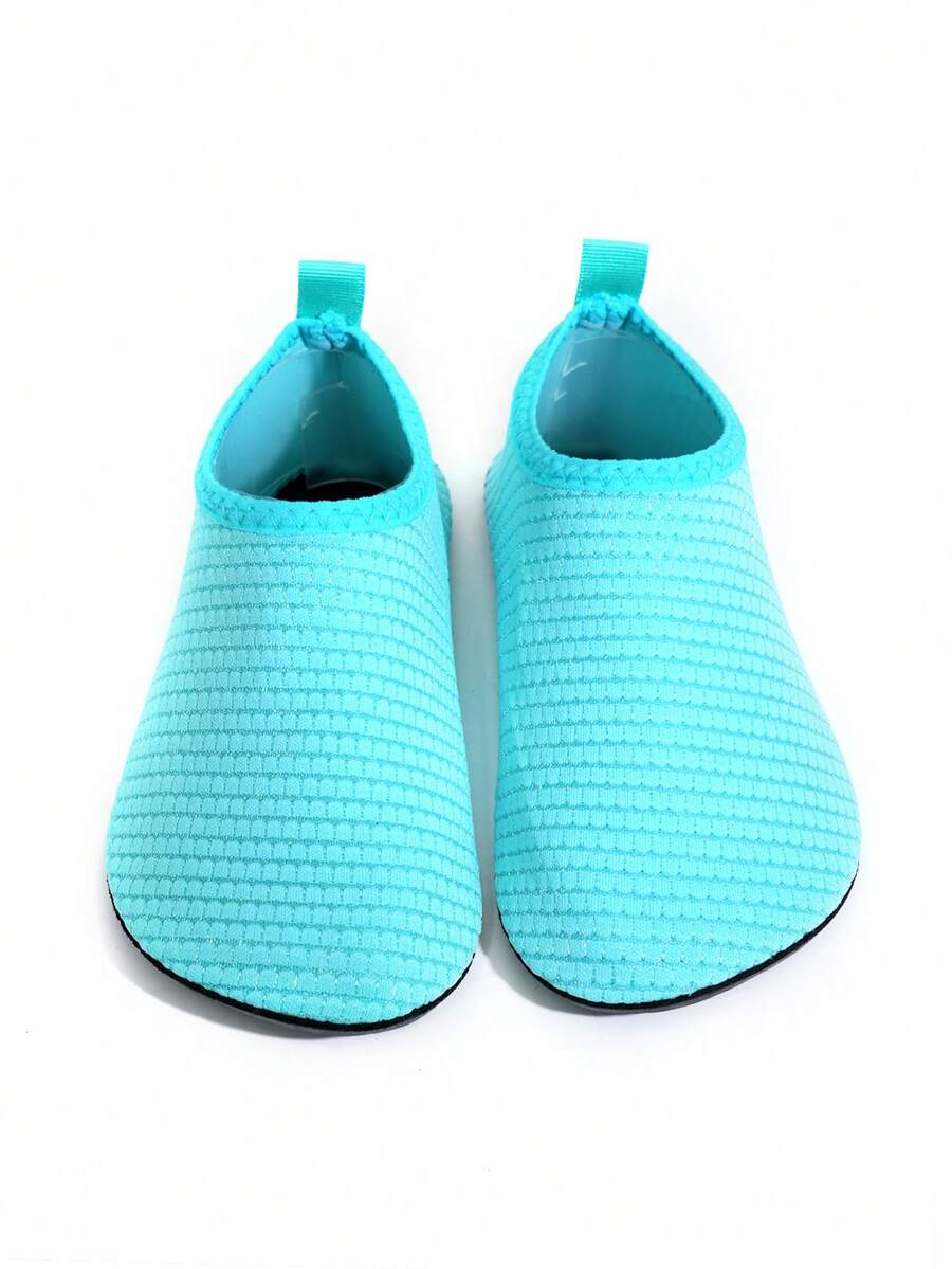 Boys breathable slip-on aqua water shoes featuring contrast binding and non-slip TPR soles for beach and outdoor activities.