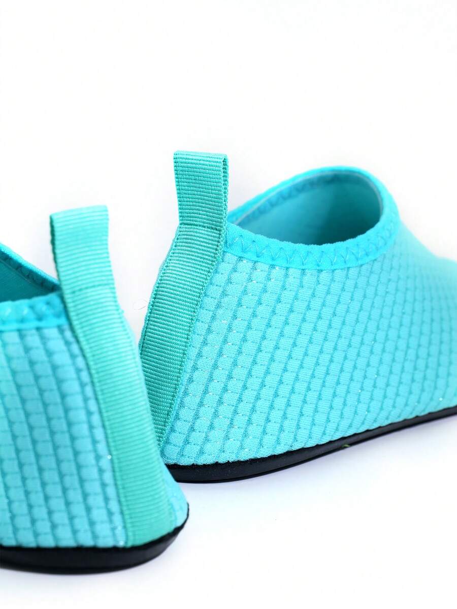 Boys breathable slip-on aqua water shoes featuring contrast binding and non-slip TPR soles for beach and outdoor activities.
