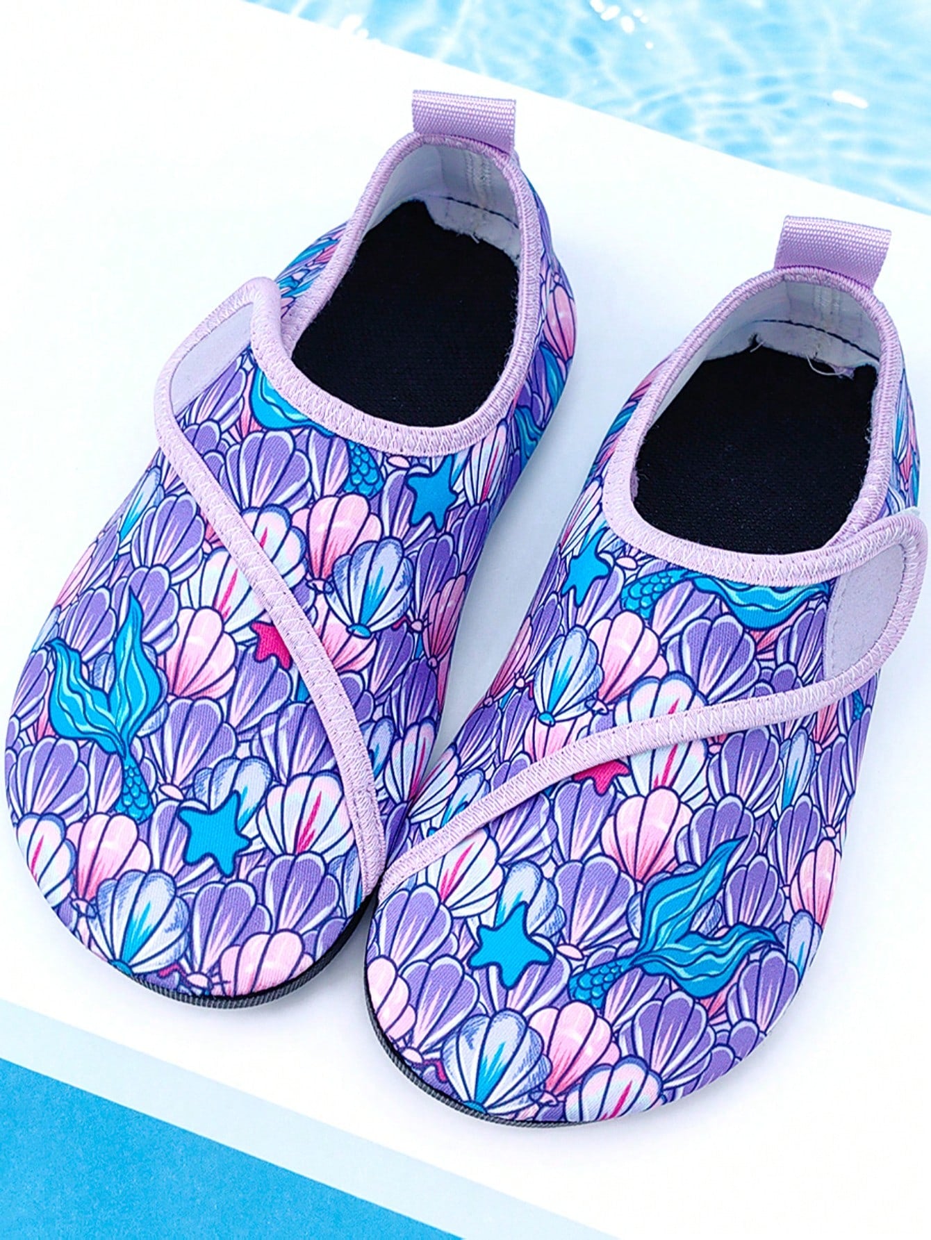 Blue kids water shoes with a shark print pattern, breathable fabric upper, and secure hook and loop closure.