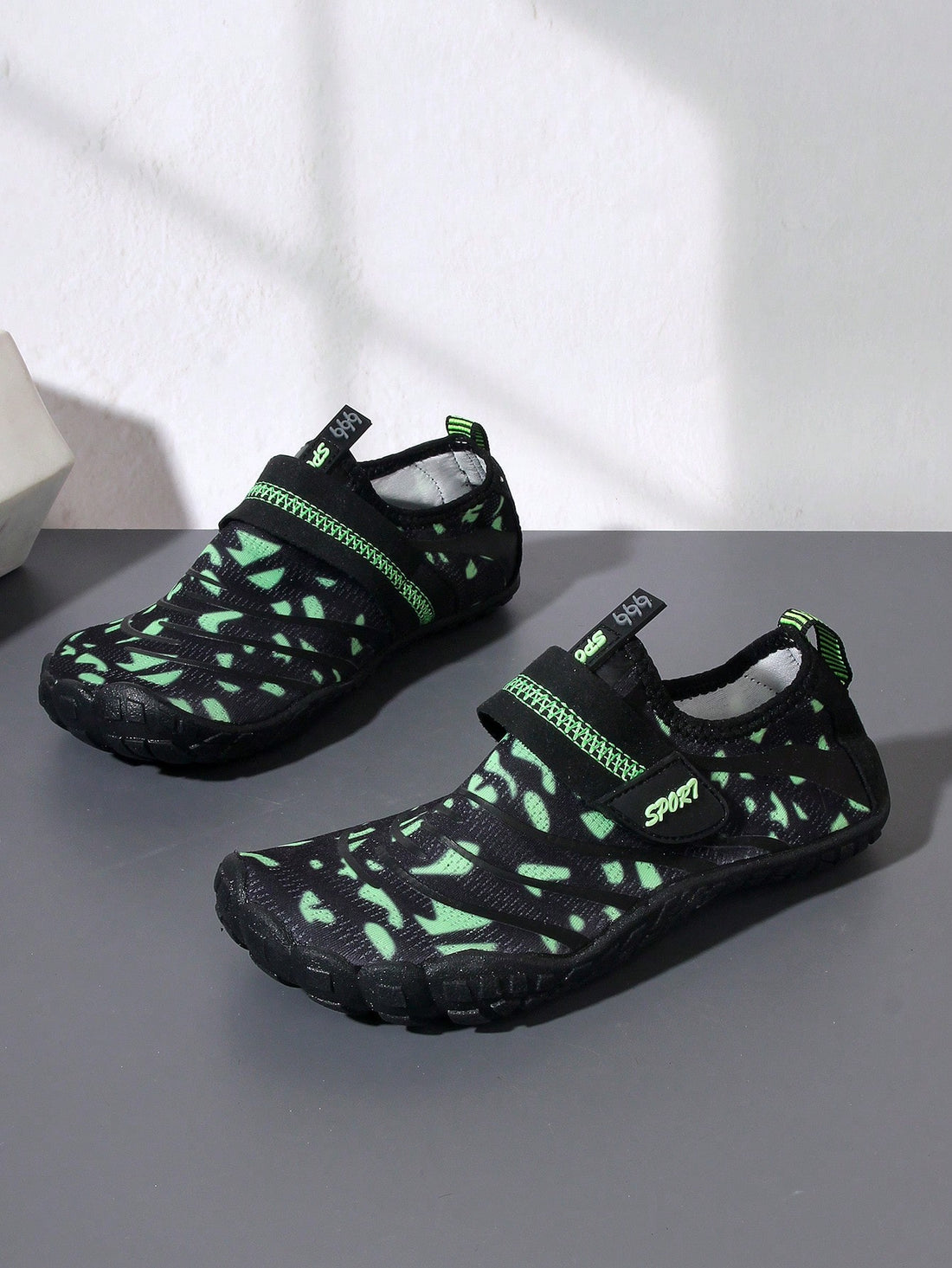 Boys green floral pattern lightweight mesh water shoes with non-slip rubber outsole and hook loop closure.