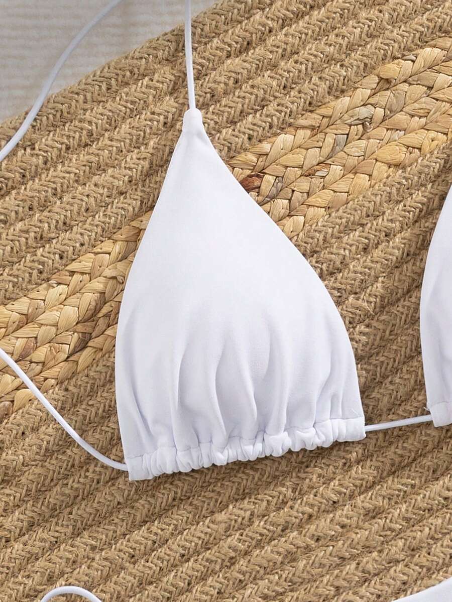 Women's 2-piece bikini set featuring a backless halter triangle top and tie-side ultra low waist bottoms.