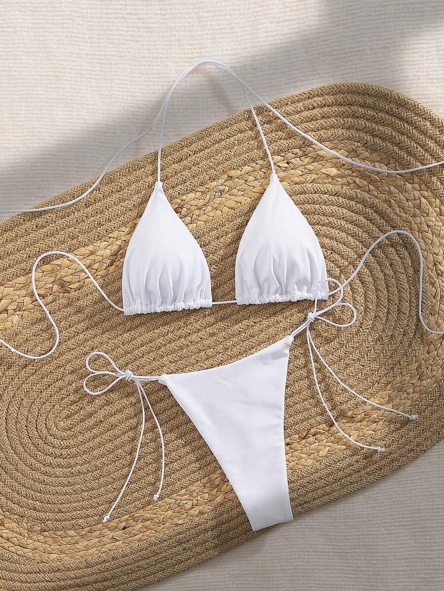 Women's 2-piece bikini set featuring a backless halter triangle top and tie-side ultra low waist bottoms.