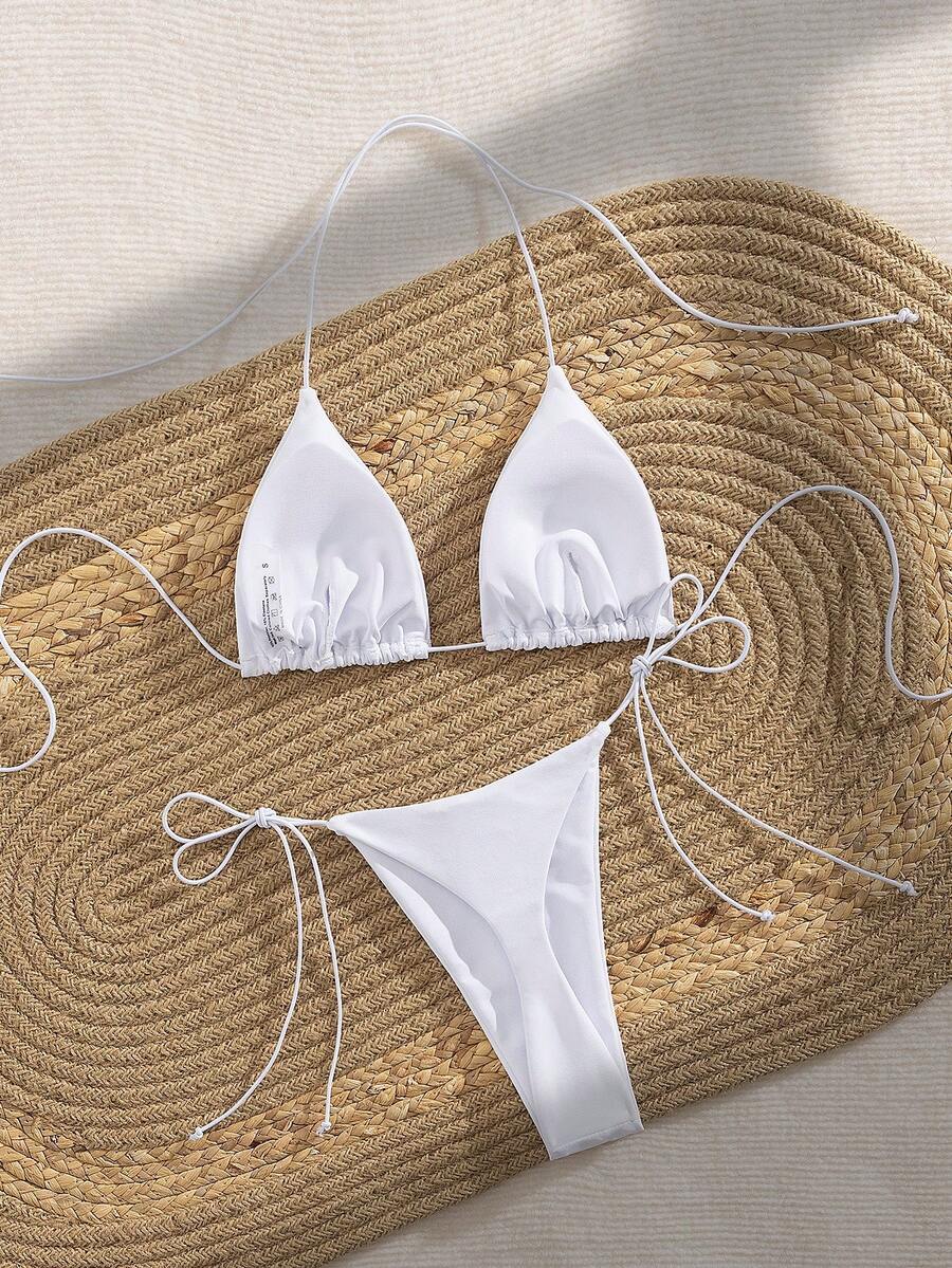 Women's 2-piece bikini set featuring a backless halter triangle top and tie-side ultra low waist bottoms.