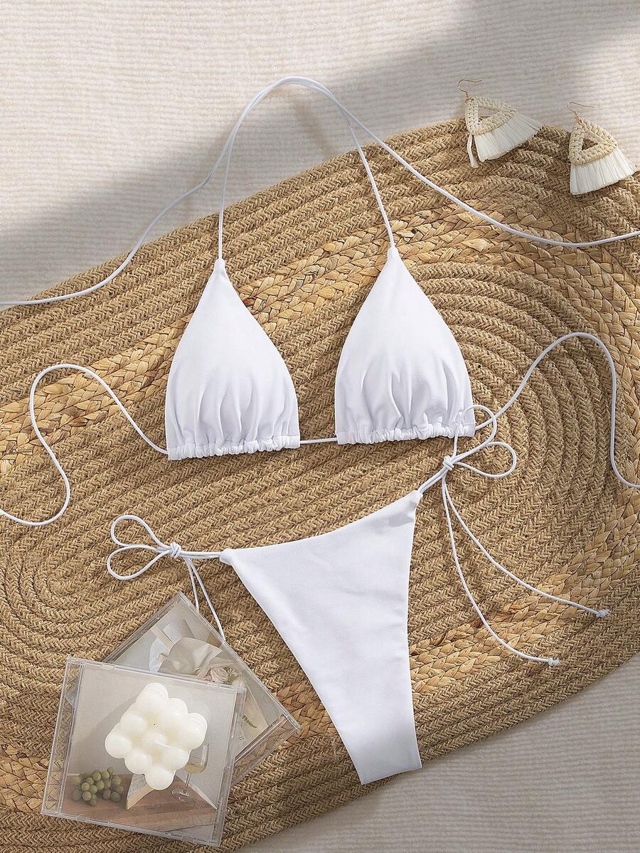 Women's 2-piece bikini set featuring a backless halter triangle top and tie-side ultra low waist bottoms.