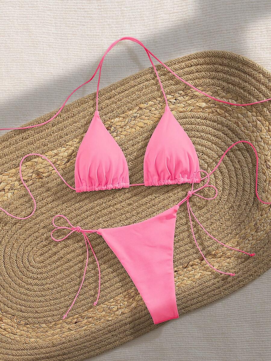 Women's 2-piece bikini set featuring a backless halter triangle top and tie-side ultra low waist bottoms.