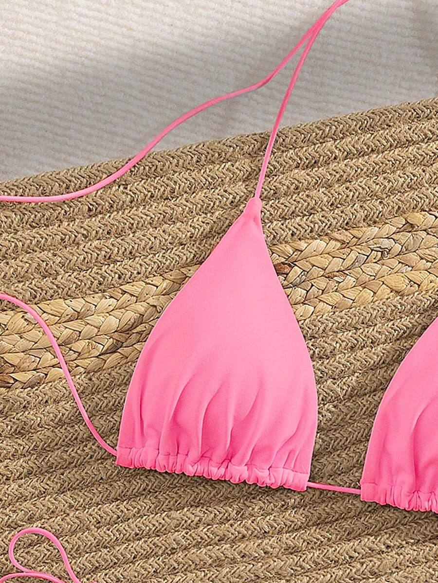Women's 2-piece bikini set featuring a backless halter triangle top and tie-side ultra low waist bottoms.