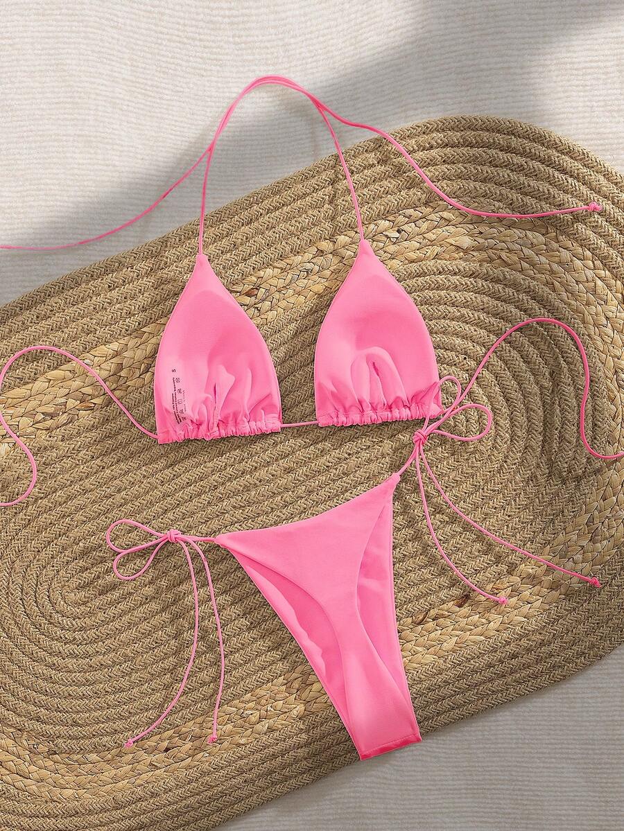 Women's 2-piece bikini set featuring a backless halter triangle top and tie-side ultra low waist bottoms.