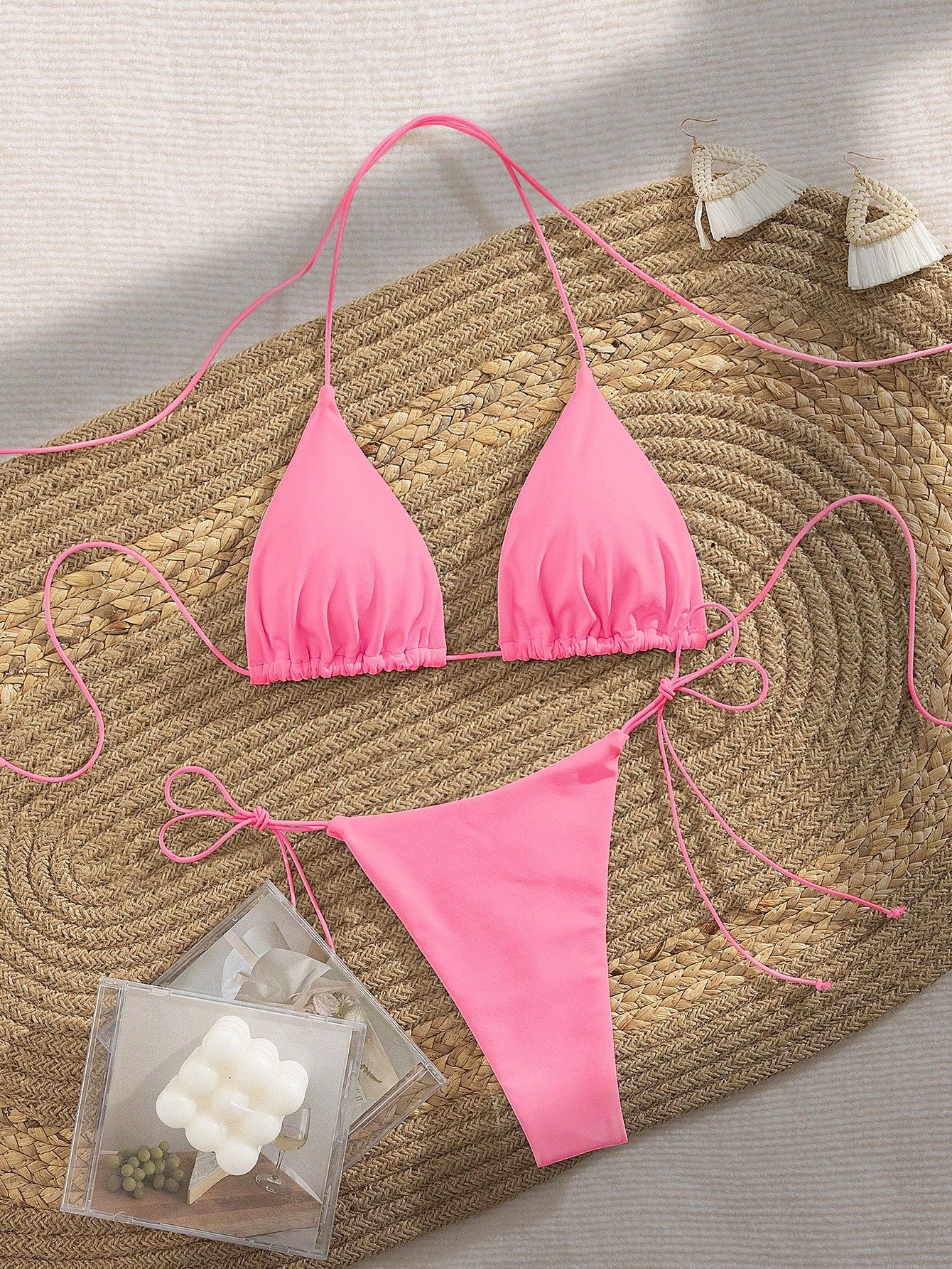 Women's 2-piece bikini set featuring a backless halter triangle top and tie-side ultra low waist bottoms.