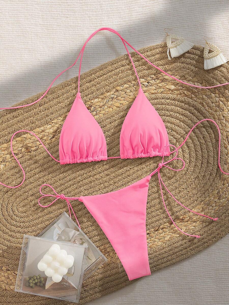 Women's 2-piece bikini set featuring a backless halter triangle top and tie-side ultra low waist bottoms.