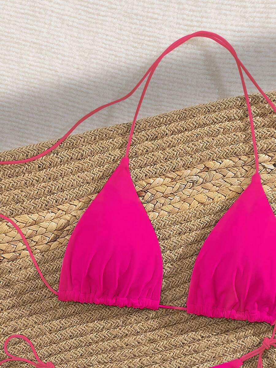 Women's 2-piece bikini set featuring a backless halter triangle top and tie-side ultra low waist bottoms.
