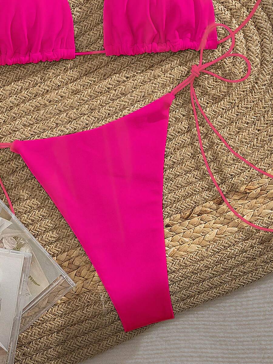 Women's 2-piece bikini set featuring a backless halter triangle top and tie-side ultra low waist bottoms.