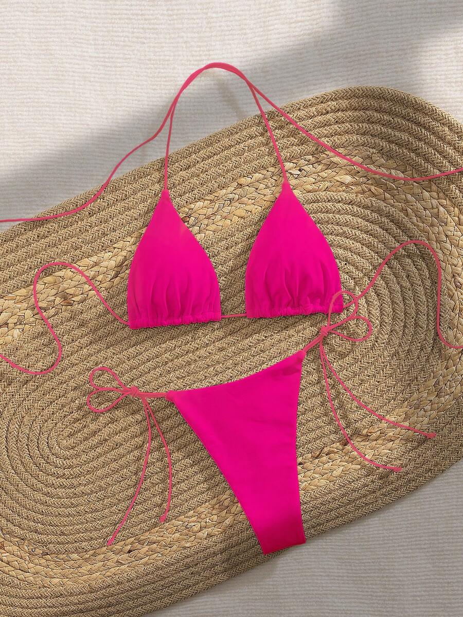 Women's 2-piece bikini set featuring a backless halter triangle top and tie-side ultra low waist bottoms.