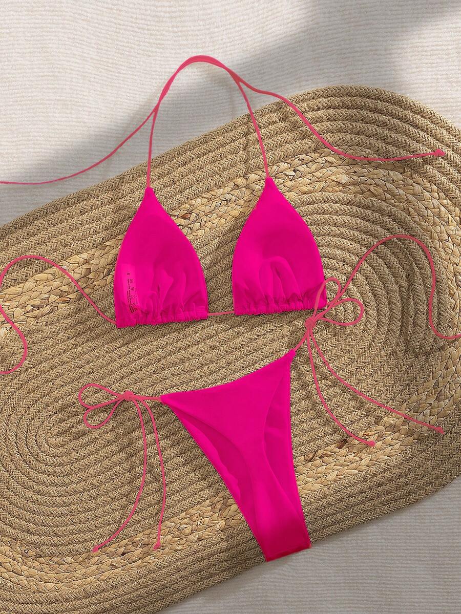 Women's 2-piece bikini set featuring a backless halter triangle top and tie-side ultra low waist bottoms.