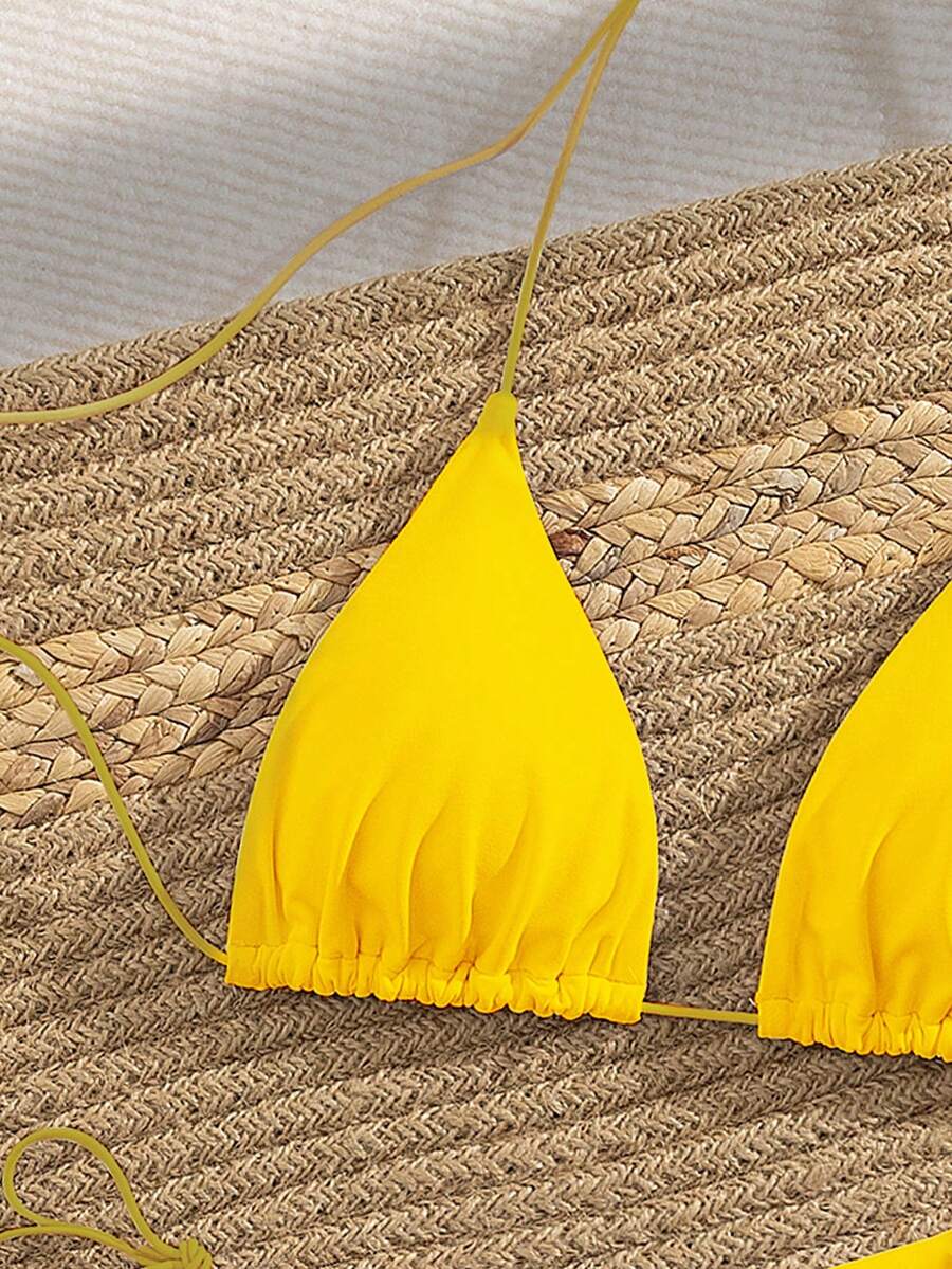 Women's 2-piece bikini set featuring a backless halter triangle top and tie-side ultra low waist bottoms.