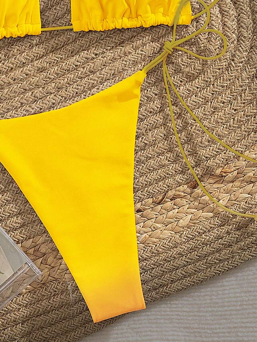 Women's 2-piece bikini set featuring a backless halter triangle top and tie-side ultra low waist bottoms.
