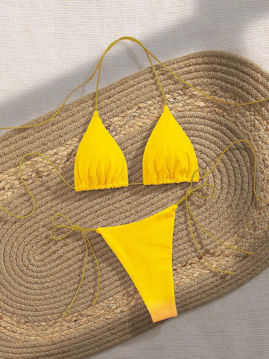 Women's 2-piece bikini set featuring a backless halter triangle top and tie-side ultra low waist bottoms.