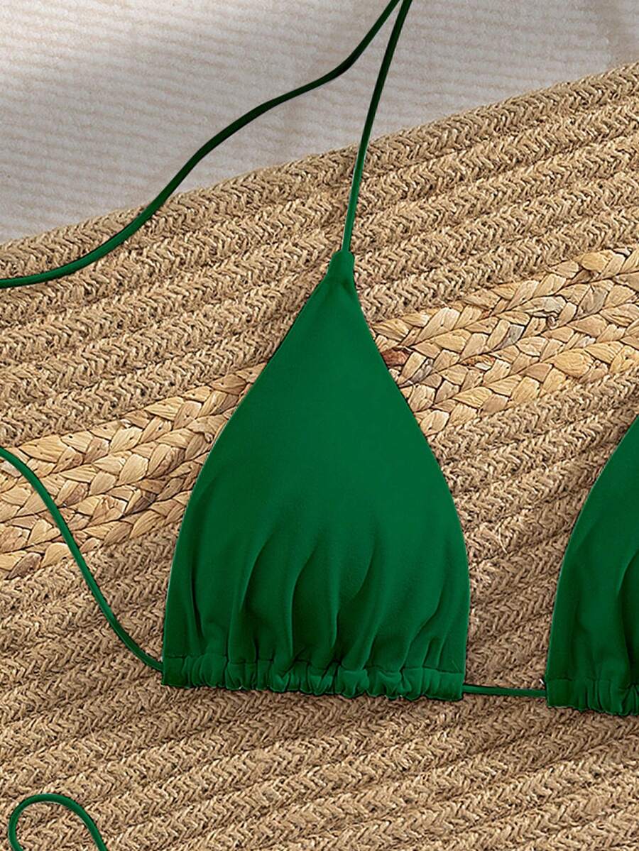 Women's 2-piece bikini set featuring a backless halter triangle top and tie-side ultra low waist bottoms.