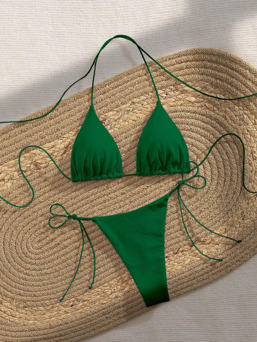 Women's 2-piece bikini set featuring a backless halter triangle top and tie-side ultra low waist bottoms.
