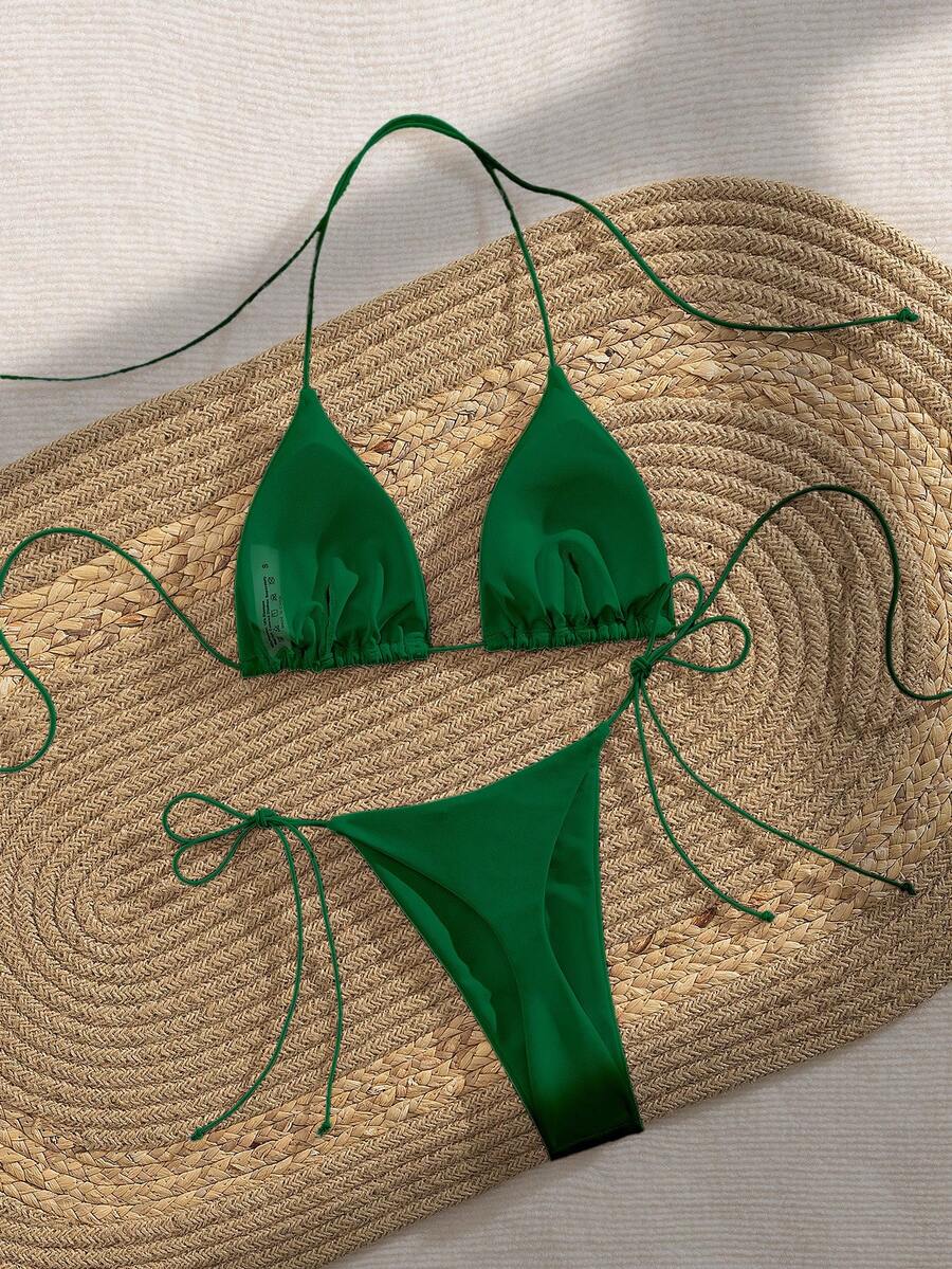 Women's 2-piece bikini set featuring a backless halter triangle top and tie-side ultra low waist bottoms.