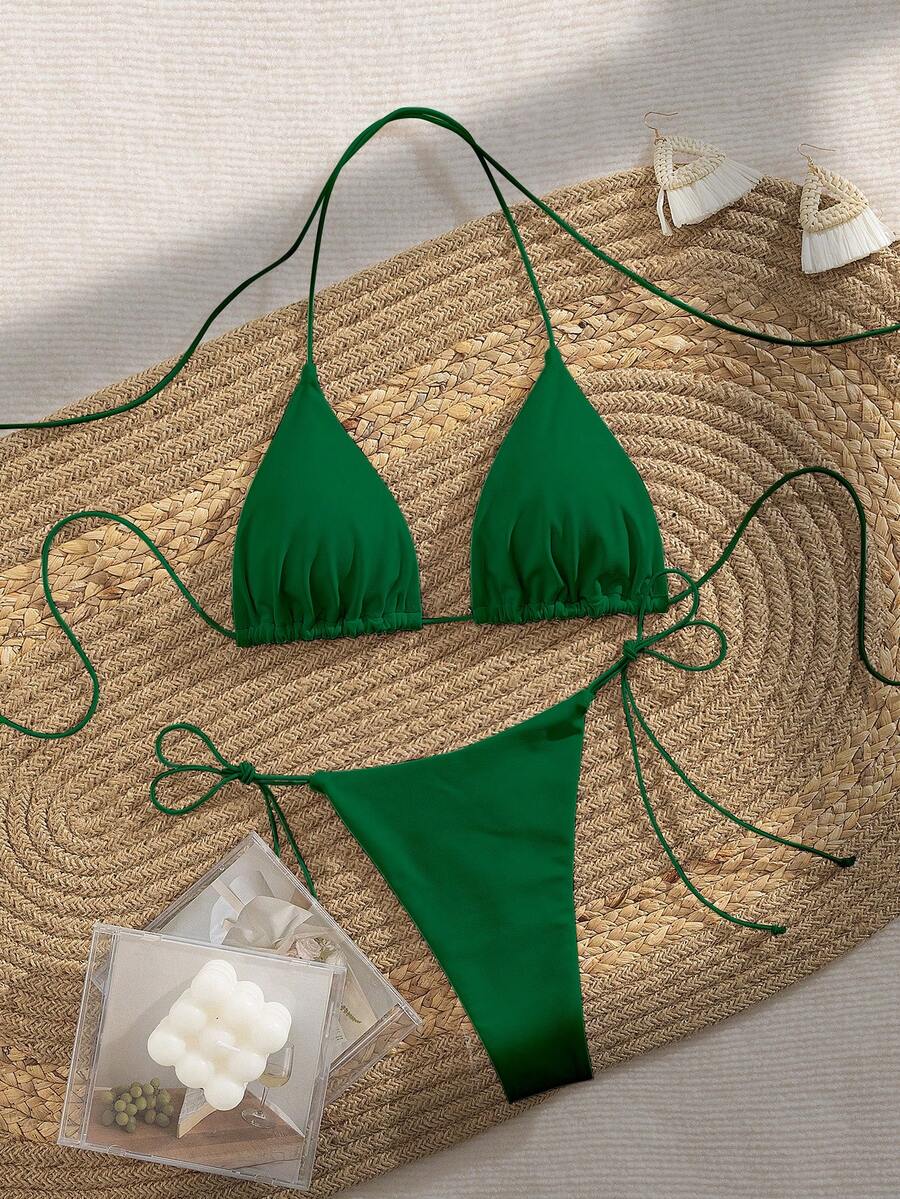 Women's 2-piece bikini set featuring a backless halter triangle top and tie-side ultra low waist bottoms.
