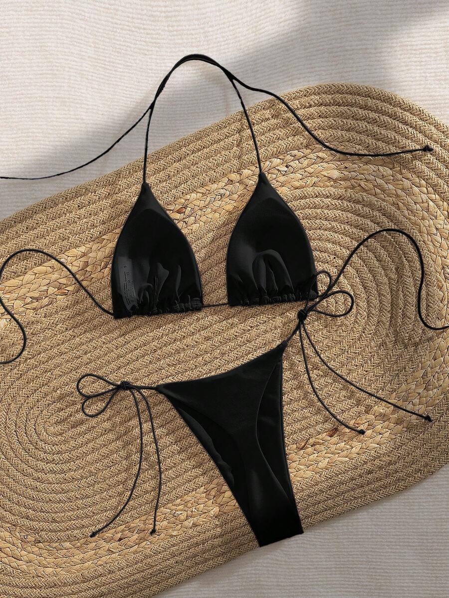 Women's 2-piece bikini set featuring a backless halter triangle top and tie-side ultra low waist bottoms.