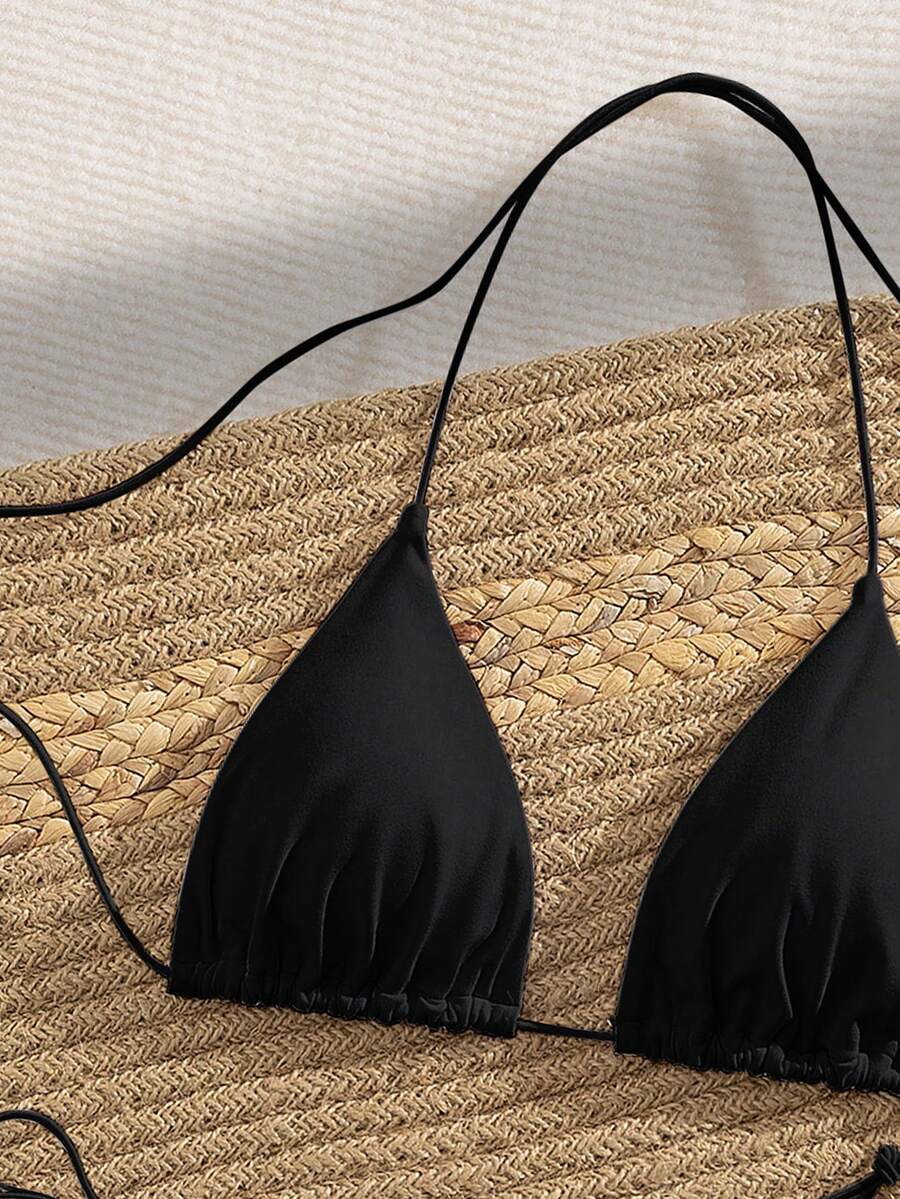 Women's 2-piece bikini set featuring a backless halter triangle top and tie-side ultra low waist bottoms.
