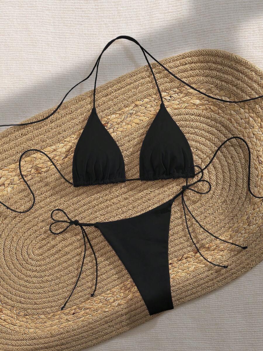 Women's 2-piece bikini set featuring a backless halter triangle top and tie-side ultra low waist bottoms.