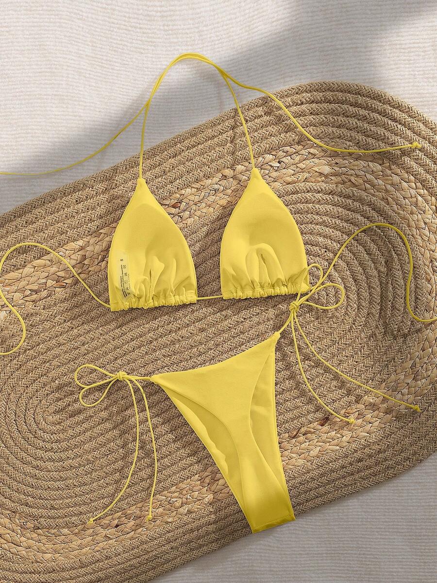 Women's 2-piece bikini set featuring a backless halter triangle top and tie-side ultra low waist bottoms.