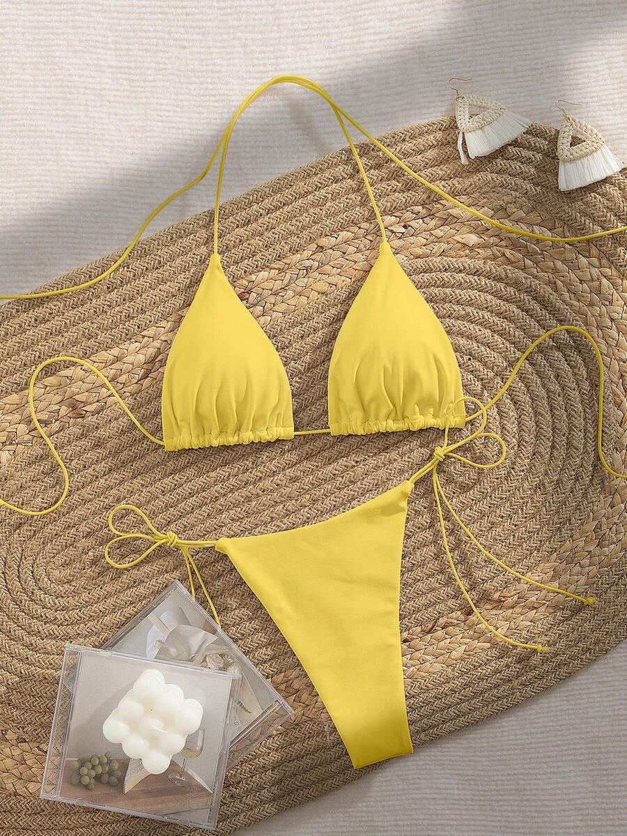Women's 2-piece bikini set featuring a backless halter triangle top and tie-side ultra low waist bottoms.