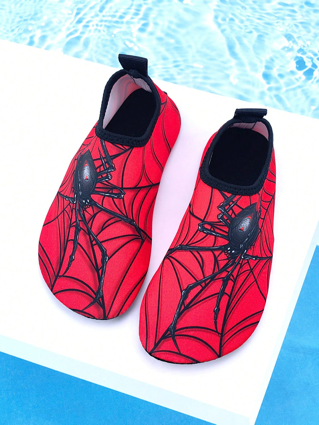 Boys red slip-on water shoes with spider pattern, breathable fabric upper, contrast binding details, and soft TPR outsole.