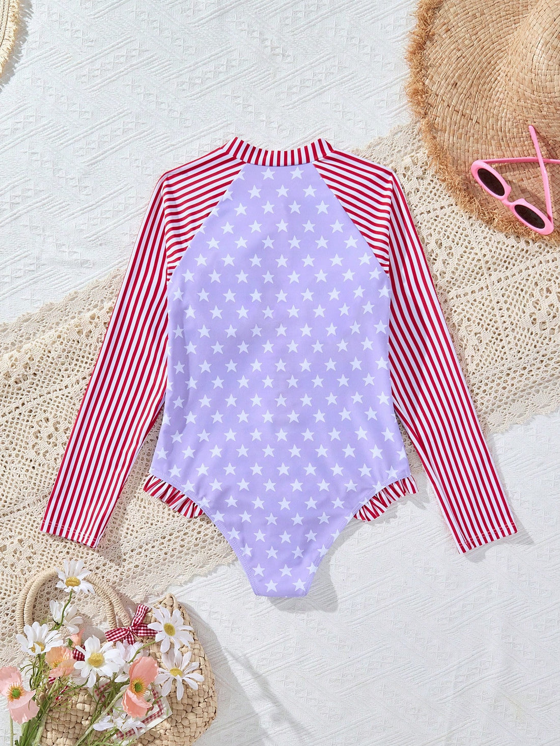 Multicolor tween girls one-piece swimsuit with striped and star patchwork design, high neck, ruffle details, zipper and button accents.