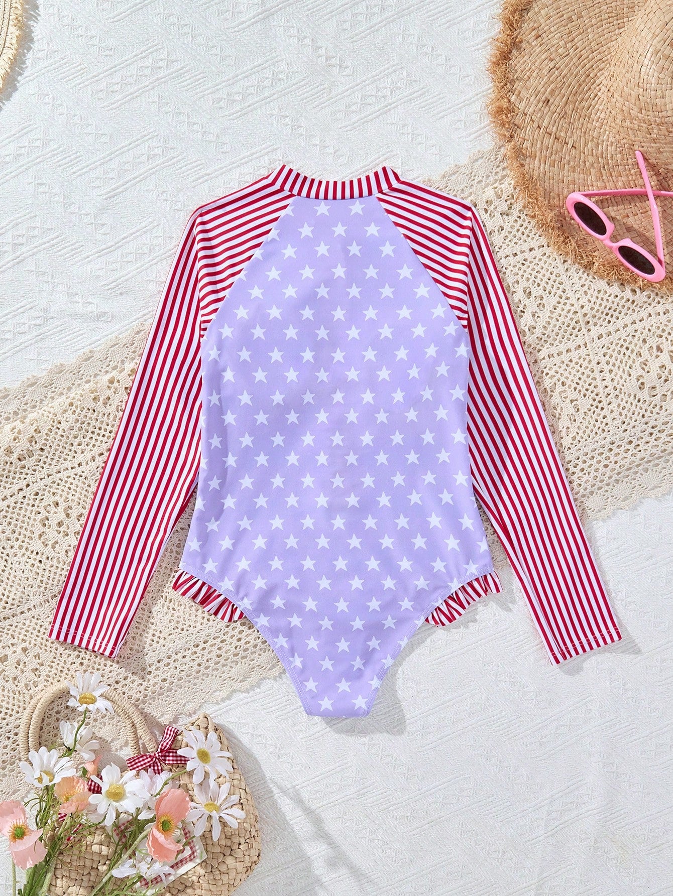 Multicolor tween girls one-piece swimsuit with striped and star patchwork design, high neck, ruffle details, zipper and button accents.