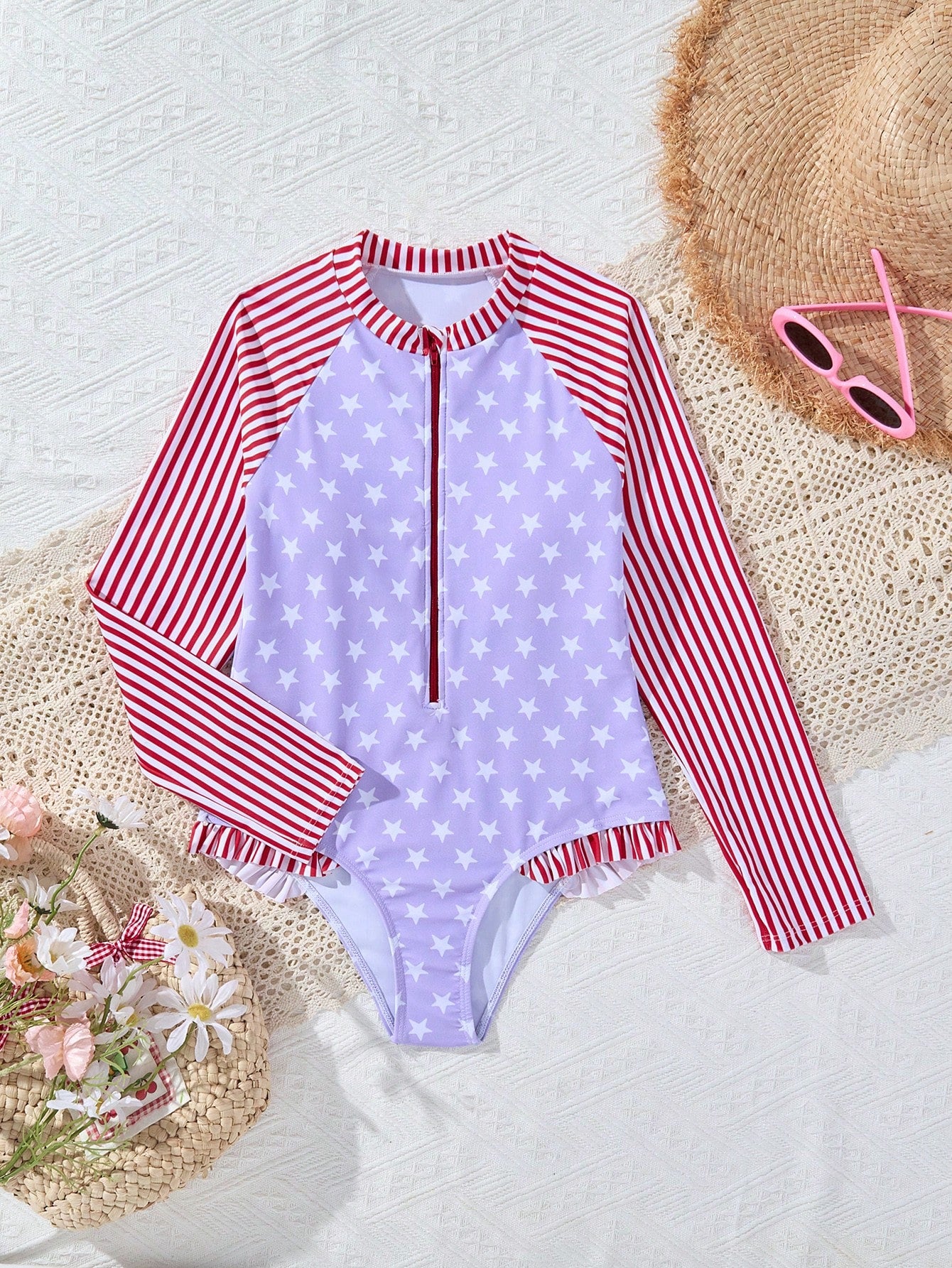 Multicolor tween girls one-piece swimsuit with striped and star patchwork design, high neck, ruffle details, zipper and button accents.