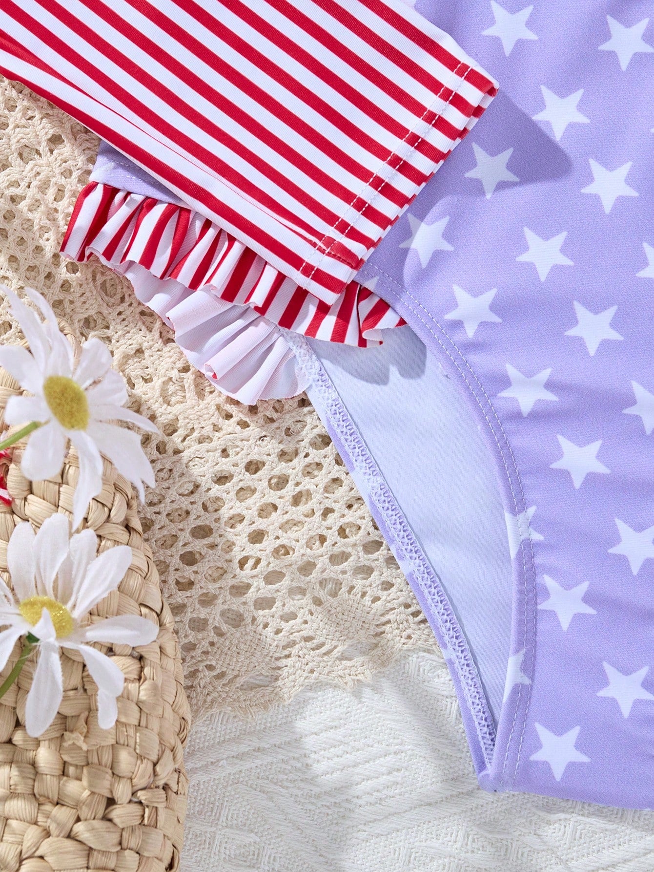 Multicolor tween girls one-piece swimsuit with striped and star patchwork design, high neck, ruffle details, zipper and button accents.