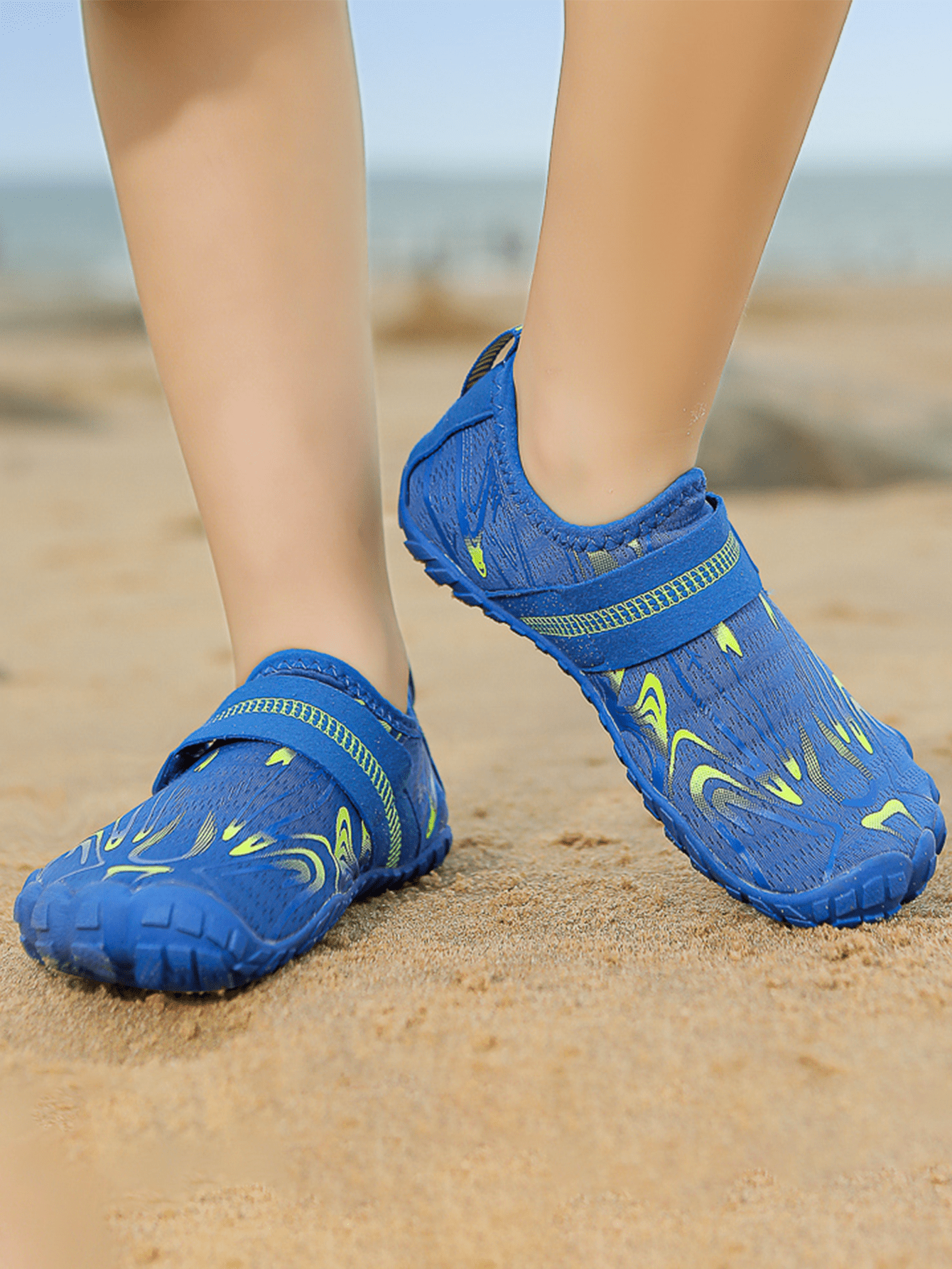 Children's water shoes featuring a breathable mesh upper, hook and loop closure, luminous details, and a non-slip outsole for boys and girls.