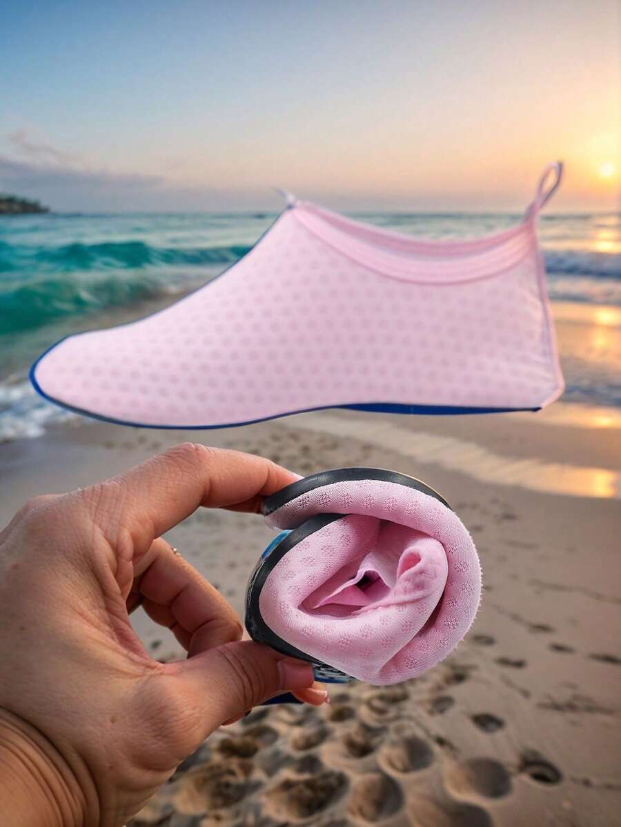 Pair of lightweight slip-on kids water shoes with breathable upper and non-slip outsole for summer beach and pool wear.