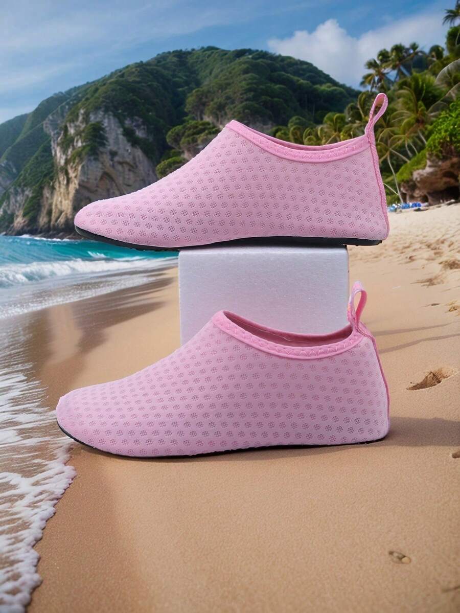 Pair of lightweight slip-on kids water shoes with breathable upper and non-slip outsole for summer beach and pool wear.