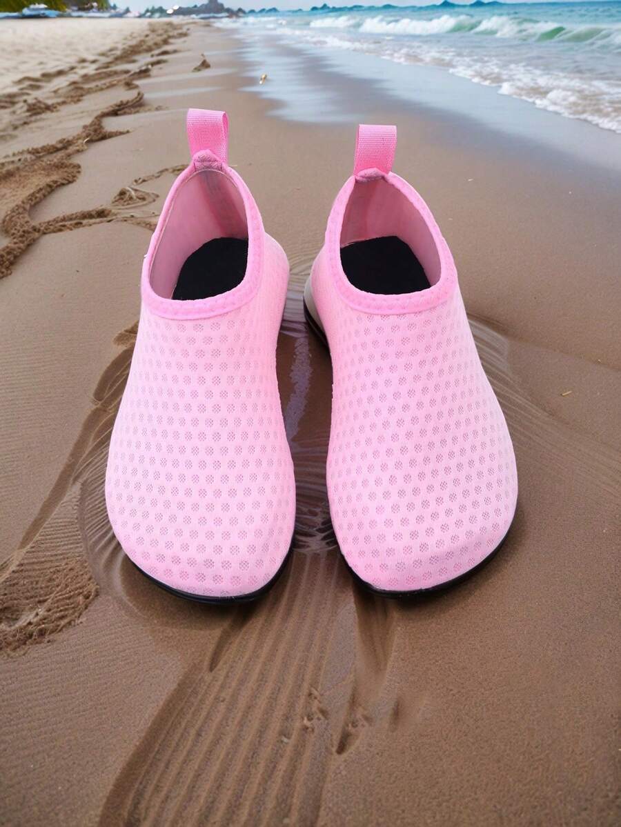 Pair of lightweight slip-on kids water shoes with breathable upper and non-slip outsole for summer beach and pool wear.