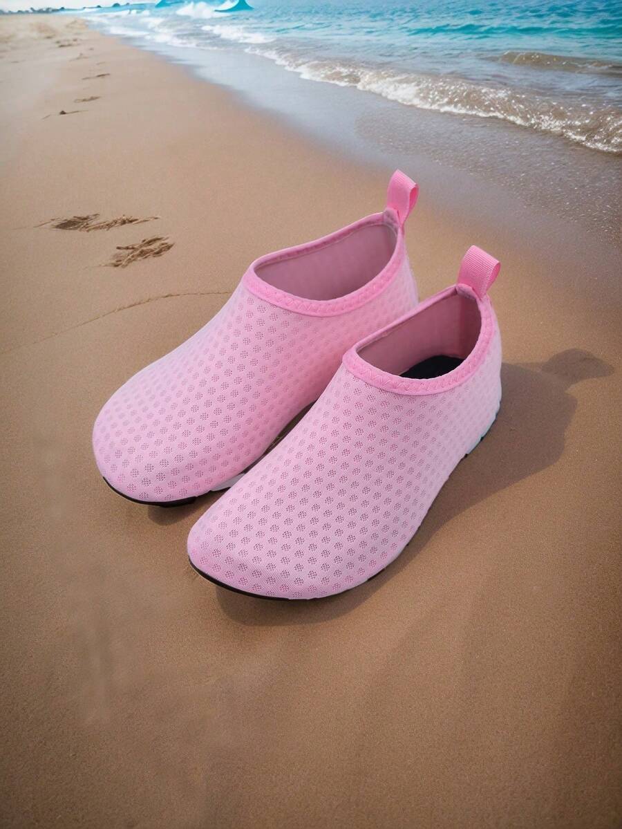 Pair of lightweight slip-on kids water shoes with breathable upper and non-slip outsole for summer beach and pool wear.