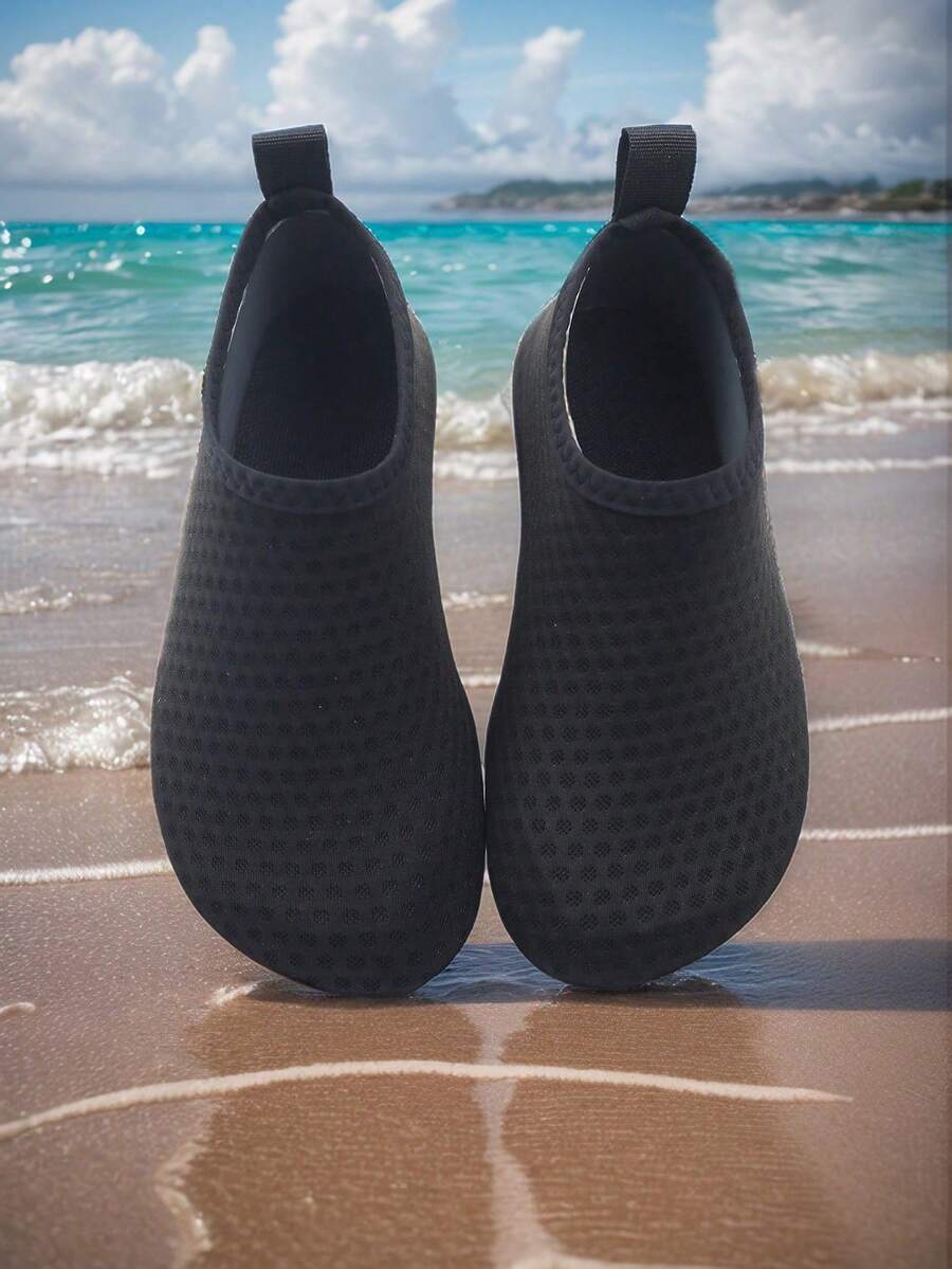 Pair of lightweight slip-on kids water shoes with breathable upper and non-slip outsole for summer beach and pool wear.