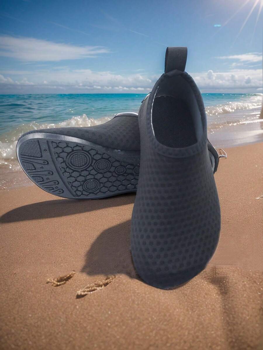 Pair of lightweight slip-on kids water shoes with breathable upper and non-slip outsole for summer beach and pool wear.