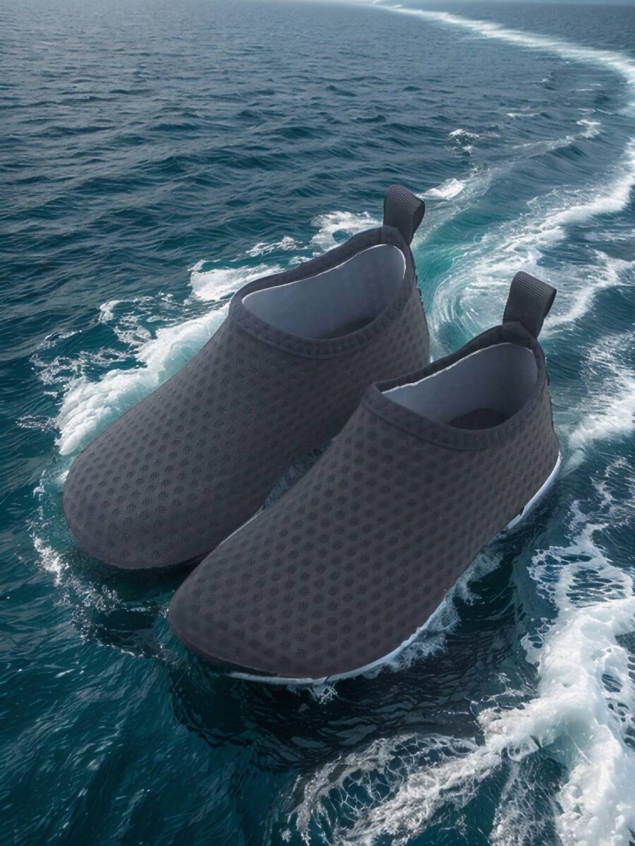 Pair of lightweight slip-on kids water shoes with breathable upper and non-slip outsole for summer beach and pool wear.
