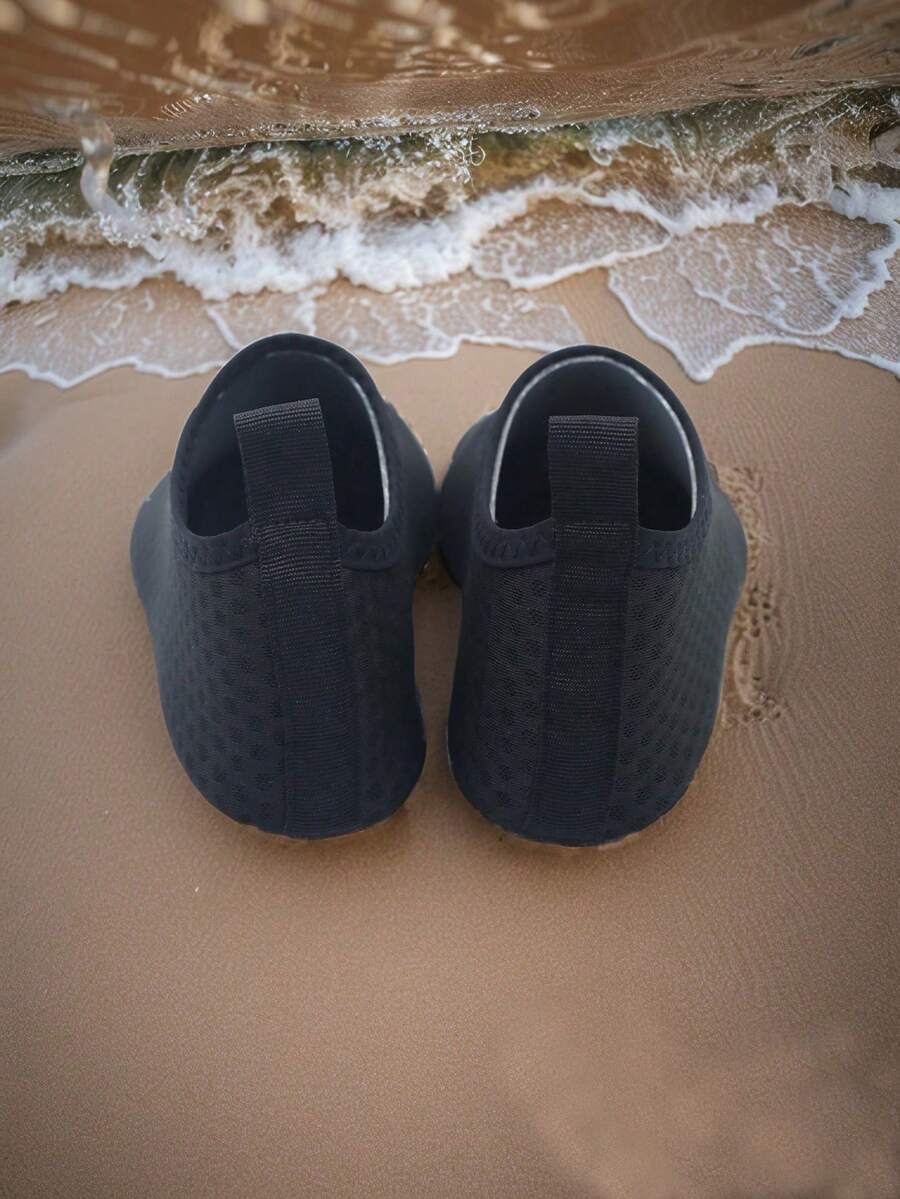 Pair of lightweight slip-on kids water shoes with breathable upper and non-slip outsole for summer beach and pool wear.