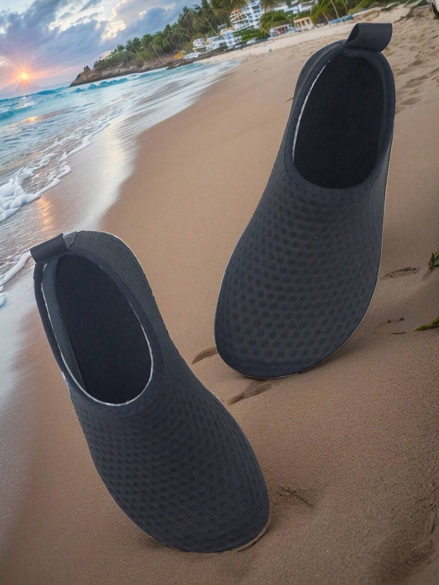 Pair of lightweight slip-on kids water shoes with breathable upper and non-slip outsole for summer beach and pool wear.