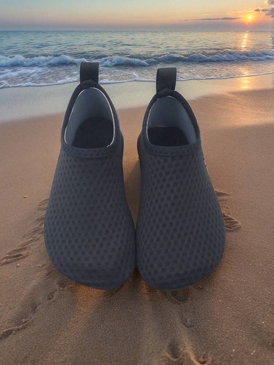 Pair of lightweight slip-on kids water shoes with breathable upper and non-slip outsole for summer beach and pool wear.