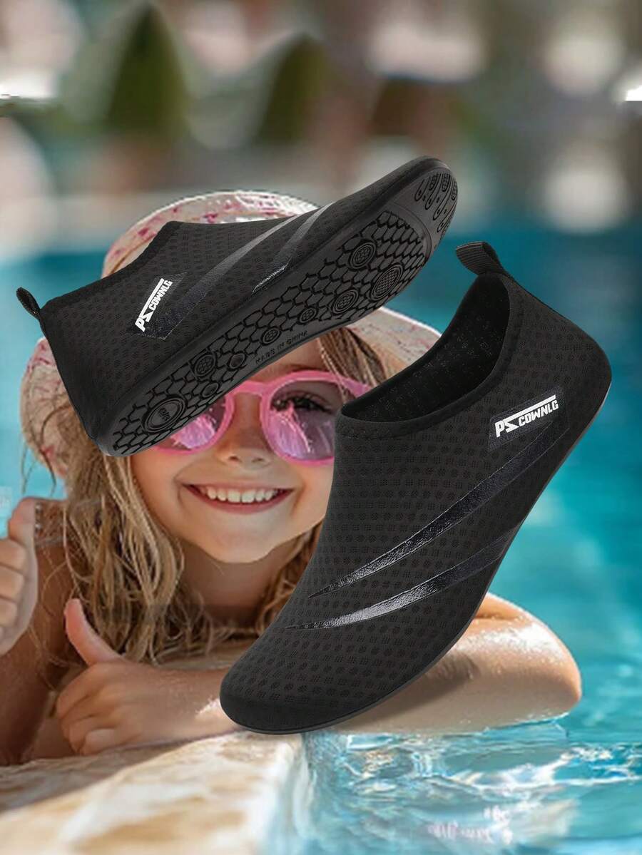 Black slip-on kids water shoes with a graphic pattern fabric upper and wear-resistant rubber outsole for boys and girls.