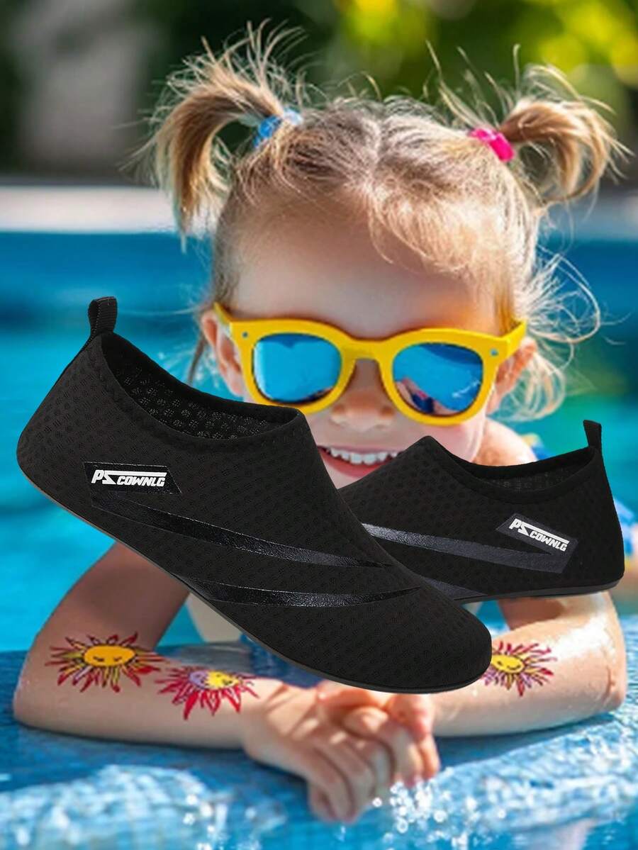 Black slip-on kids water shoes with a graphic pattern fabric upper and wear-resistant rubber outsole for boys and girls.