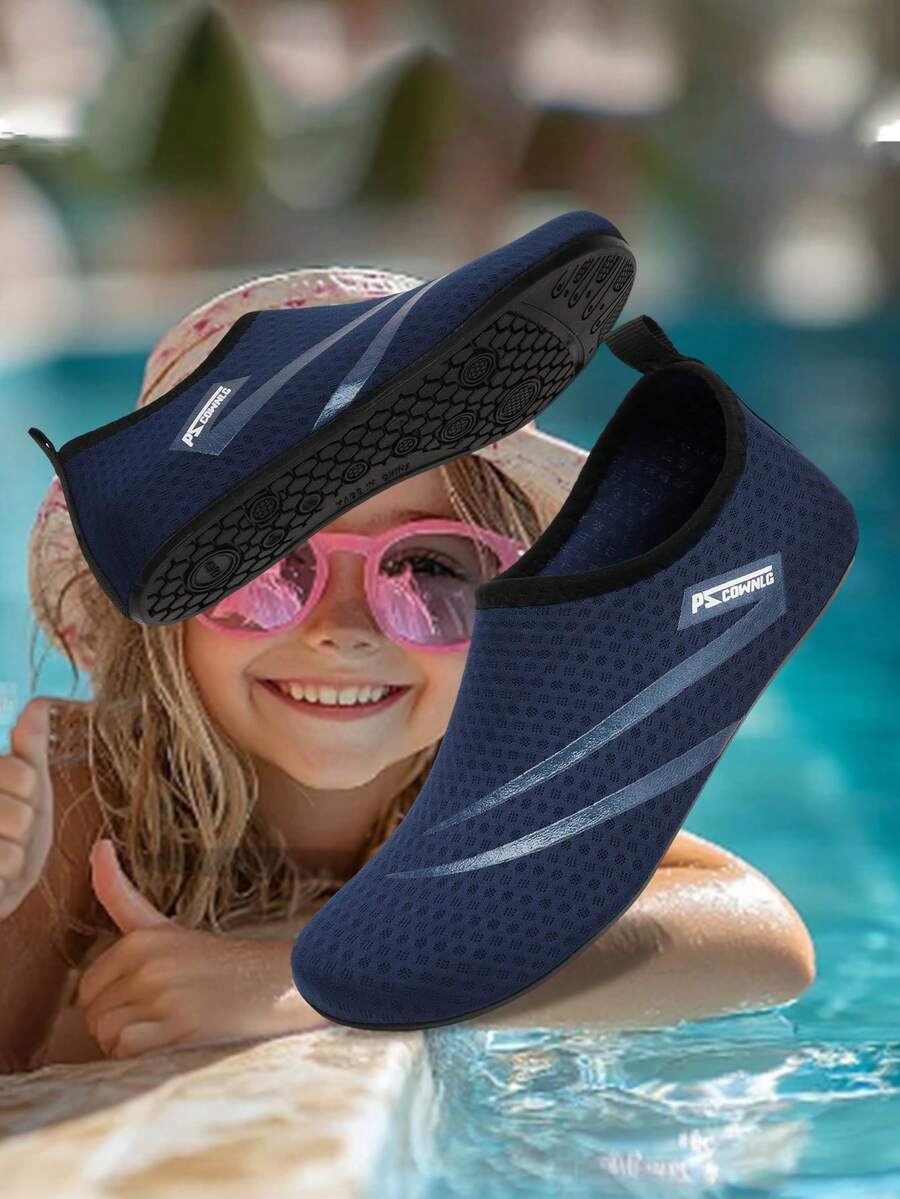 Black slip-on kids water shoes with a graphic pattern fabric upper and wear-resistant rubber outsole for boys and girls.